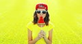 Summer portrait of happy young woman eating fresh lollipop or ice cream shaped slice of watermelon on the grass in the summer park Royalty Free Stock Photo