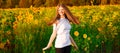 Summer portrait of happy young woman in hat with long hair in field enjoying nature Royalty Free Stock Photo