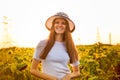 Summer portrait of happy young woman in hat with long hair in sunflower field Royalty Free Stock Photo