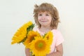 Summer portrait of kid with flowers. Smiling boy with bouquet of sunflowers. Lovely child romantic and surprise. Royalty Free Stock Photo