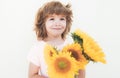 Summer portrait of kid with flowers. Smiling boy with bouquet of sunflowers. Lovely child romantic and surprise. Royalty Free Stock Photo