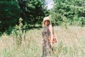 Summer portrait of mature adult blonde woman sitting in a grass on sunny day in the meadow Royalty Free Stock Photo