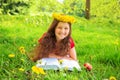 Merry child reads book among the dandelions.