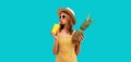 Summer portrait of stylish happy young woman drinks fresh juice with pineapple fruits wearing sunglasses, straw hat posing on blue Royalty Free Stock Photo