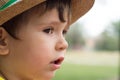 Summer portrait toddler boy in straw hat.