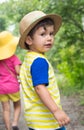 Summer portrait toddler boy in straw hat.