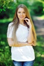 Summer portrait of young smiling blonde woman outdoor