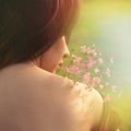 Summer portrait of young woman with flower back shot closeup outdoors