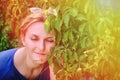 Summer portrait of a young woman with glasses, copy space. Girl face close-up on a background of green leaves. Happy woman in a Royalty Free Stock Photo