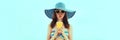Summer portrait of young woman model drinking fresh juice wearing straw hat on the beach on sea background Royalty Free Stock Photo
