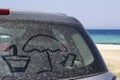 Summer props drawn on the back of a dirty car window. Lifestyle Royalty Free Stock Photo