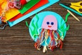 Summer puppet stics toy octopus on a wooden table. Handmade. Childrens creativity project. Royalty Free Stock Photo