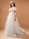 Summer radiance wedding gown with flutter lace sleeves and floral garland. Bridal inspiration. Royalty Free Stock Photo