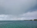 Summer rains over entrance to North Bimini channel, Bahamas. Royalty Free Stock Photo