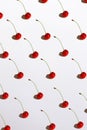 Summer red ripe cherries pattern with dark hard shadows on the white background isolated. Top view, free copy space Royalty Free Stock Photo