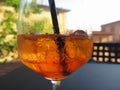 Summer refreshing aperitif drink on the rocks . Spritz cocktail with lemon slice