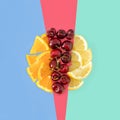 Summer refreshing circle concept. Organic orange, cherry and lemon. Flat lay healthy meal on pastel blue, red, green background Royalty Free Stock Photo