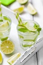 Summer refreshing cocktail caipirinha with lime and mint on white wooden vintage background. Royalty Free Stock Photo