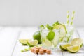 Summer refreshing cocktail caipirinha with lime and mint on white wooden vintage background. Royalty Free Stock Photo