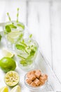 Summer refreshing cocktail caipirinha with lime and mint on white wooden vintage background. Royalty Free Stock Photo