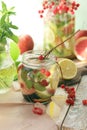 Summer refreshing cocktail, detox water from organic fruits and berries, mint leaves in glass jugs