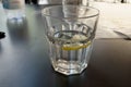 Summer refreshing drink on the rocks with lemon slice . Glass on the table