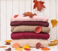 Background of of knitted woolen clothes with autumn leaves. Knitted texture