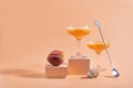 Summer refreshing fruit cocktail bellini of fresh ripe peach and champagne in glasses on modern abstract podium Royalty Free Stock Photo