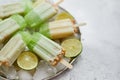 Summer refreshing homemade lime popsicles with chipped ice over stone background Royalty Free Stock Photo