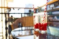 Summer refreshing lemonade with rasberry on a balcony of terrace