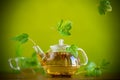 Summer refreshing organic tea from currant leaves in a glass teapot