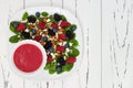 Summer refreshing spinach mixed berry salad with pumpkin and sunflower seeds, almonds, feta cheese and red raspberry vinaigrette Royalty Free Stock Photo