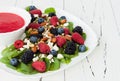 Summer refreshing spinach mixed berry salad with pumpkin and sunflower seeds, almonds, feta cheese and red raspberry vinaigrette Royalty Free Stock Photo