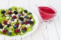 Summer refreshing spinach mixed berry salad with pumpkin and sunflower seeds, almonds, feta cheese and red raspberry vinaigrette Royalty Free Stock Photo