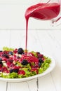 Summer refreshing spinach mixed berry salad with pumpkin and sunflower seeds, almonds, feta cheese and red raspberry vinaigrette Royalty Free Stock Photo