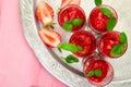 Summer refreshing strawberry sorbet, slush granita drink in serving glasses on silver tray