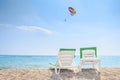 Summer rest background. Two deck chairs on sea beach on clear sunny day. Relax on the beach. Tropical resort concept Royalty Free Stock Photo