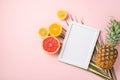 Summer rest concept. Top view photo of white photo frame and ripe tropical fruits cut lemon orange grapefruit pineapple and palm