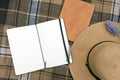 Summer rest mock up with hat and diary on a plaid mat, outdoor flat lay photo