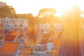 Summer in Rimini, Italy. Sun umbrellas and deck chairs on sandy sea beach in Rimini. Summer vacation on seashore