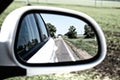 Summer road in the reflection of the rear view mirror Royalty Free Stock Photo