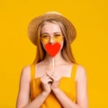 Summer Romance. Playful Young Girl Covering Mouth With Red Paper Heart Royalty Free Stock Photo