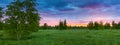 Summer rural landscape with forest, a meadow and fog at sunrise