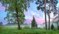 Summer rural landscape with forest, a meadow and fog at sunrise Royalty Free Stock Photo