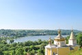 Summer rural landscape with orthodox church, forest and lake in distance