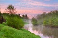 Summer rural landscape with river, forest and fog at sunrise Royalty Free Stock Photo