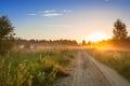 Summer rural landscape with sunrise , fog and the road