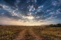 Summer rural landscape with sunrise and the road. Royalty Free Stock Photo