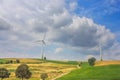 Summer rural landscape - view of wind farms on agricultural fields Royalty Free Stock Photo