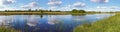 Summer rushy lake panorama view with clouds reflections Royalty Free Stock Photo